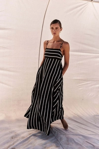 Detail of a black and white striped maxi dress with thin straps and airy fabric