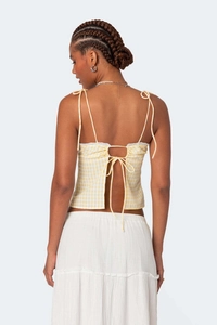 Macro view of the yellow gingham crop top featuring backless lace trim and drawstring details