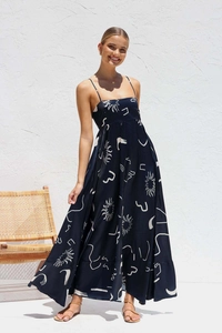 Detail of high-waist maxi dress featuring sun and moon prints in navy blue and white