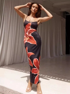 Chic black bodycon cami dress with large red lily floral print and slim fit silhouette