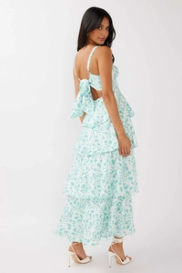 Detail of floral maxi dress with large back bow tie and elegant tiered ruffled skirt