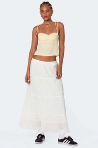 Full view of yellow checkered tie-shoulder camisole and white tiered maxi skirt outfit