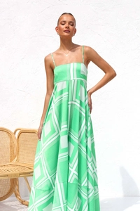 Close-up of lightweight green and white geometric print maxi dress with a flowy A-line hem