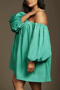 Detail view of mint green off-shoulder satin dress with dramatic puff sleeves texture