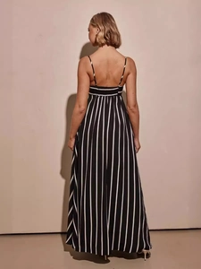 Elegant black and white vertical striped backless maxi dress with thin straps and full skirt