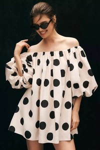 Detailed view of puff sleeves and off-the-shoulder polka dot dress texture