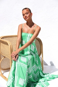 Detailed close-up of summer maxi dress with green geometric patterns and thin straps