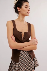 Close-up of dark coffee knit vest with ribbed texture, lace trim, and button front