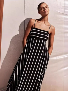 Minimalist black and white striped backless maxi dress with thin straps and side pockets
