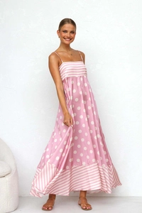 Detailed view of pink polka dot and striped fabric on a flowing summer maxi dress