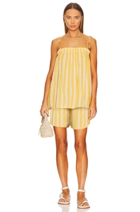 Detailed view of yellow and white striped two-piece summer set with ruffled camisole and shorts