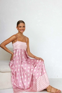 Detail of summer dress featuring pink polka dots and striped stitching on lightweight fabric