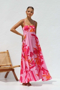 Detail of pink floral maxi dress with thin straps and vibrant tropical flower prints