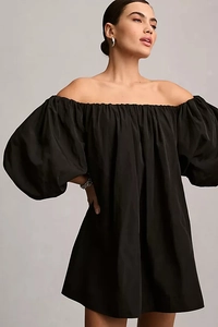 Detail of off-the-shoulder neckline and puffy sleeves on a black mini dress