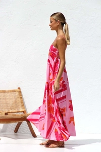 Detail of floral print maxi dress featuring red and orange flowers on pink chiffon fabric