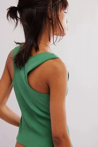 Close-up of green ribbed knit tank top with scalloped lace trim and back cutout detail