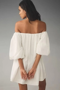 Back view of a white off-shoulder puff sleeve dress with elastic pleated neckline detail