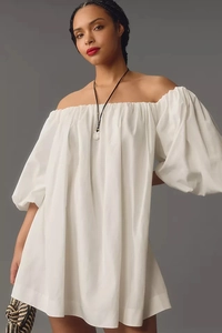 Detailed view of elastic off-shoulder neckline and puffy balloon sleeves on white dress