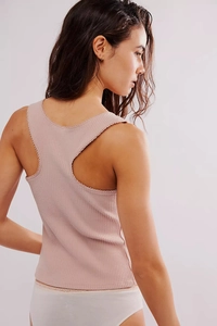 Close-up of ribbed knit texture and lace trim on a dusty pink racerback tank top