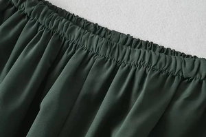Detail of high-elastic elastic waistband with stitching on dark green casual pants