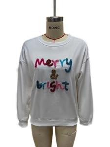 Close-up of colorful merry & bright plush embroidery on white round neck sweatshirt