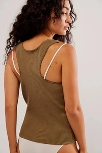 Close-up of olive green ribbed knit top with delicate lace trim on the racerback neckline
