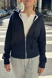 Detail of navy blue zip-up hoodie featuring silver metal zipper and adjustable drawstring