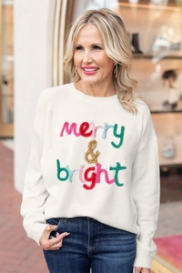 Detail of colorful merry & bright 3D embroidery on white long sleeve knit sweater