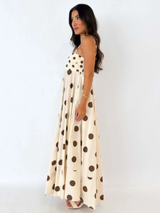 Off-white maxi sundress with brown polka dots featuring a backless A-line silhouette