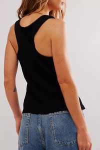Detail of black ribbed knit racerback top featuring delicate scalloped edge trimming