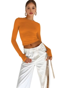 Slim fit bright orange long sleeve crop top with thumb holes and white cargo pants