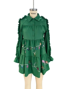 Emerald green Christmas tiered dress featuring ruffled sleeves and sequin light patterns