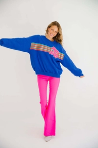 Detail of blue festive sweatshirt with Merry & Bright embroidery and rainbow stripes