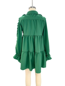 Rear view of dark green tiered long sleeve dress with collar and pleat details