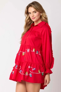 Close-up of red Christmas babydoll dress with colorful sequin string light patterns