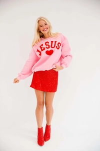 Fashionable pink crewneck sweatshirt with red heart embroidery and sequined mini skirt detail