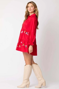 Detail of red tiered Christmas dress with colorful light bulb sequin embroidery and ruffles