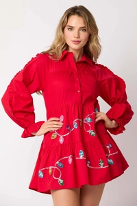 Detail of Christmas dress with colorful sequin light patterns and ruffled sleeve layers