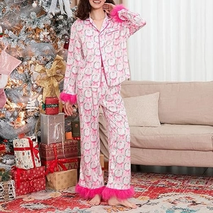 Detail of pink Christmas satin pajama set featuring festive prints and luxury faux fur cuffs