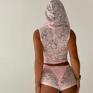Rear view of model wearing a light pink floral lace two-piece lounge set with hood