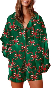 Detail of Christmas pajamas set in dark green satin with red ribbon bow patterns