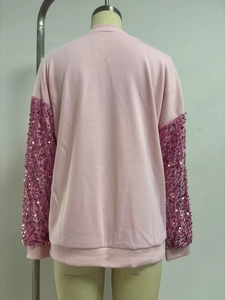 Rear view detail of a pink long sleeve sweatshirt featuring sparkly sequined sleeves and ribbed cuffs