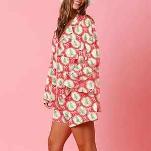 Detail of Christmas pajama set with festive tree and bow patterns on soft long-sleeve fabric