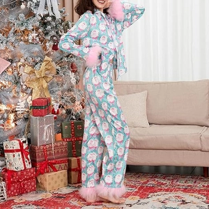 Detail of Christmas pajamas featuring Santa prints and pink faux feather trim on sleeves