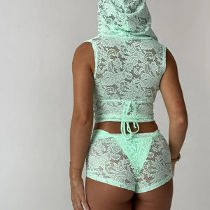 Rear view of mint green lace two-piece set featuring hooded crop top and matching shorts