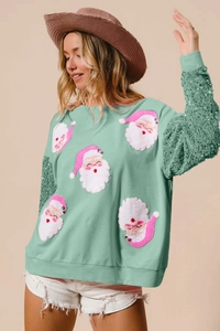 Detail of sequined sleeves and pink Santa embroidery on mint green Christmas sweatshirt