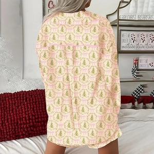Rear view of a soft yellow Christmas pajama set with green trees and pink bows