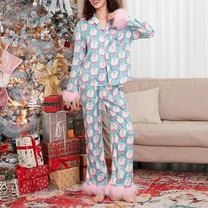Detail of Christmas satin pajama set with Santa print and pink faux fur trim cuffs