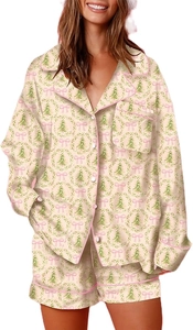 Detail of Christmas pajama set featuring green tree and pink bow patterns on silky fabric