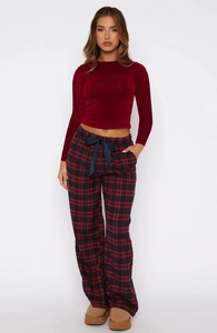 Detail of burgundy long sleeve crop top with red and black plaid drawstring pants set